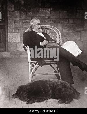 1870s ELDERLY BEARDED MAN SITTING IN WICKER CHAIR ON PORCH OF STONE HOUSE HOLDING A NEWSPAPER A BLACK DOG LYING AT HIS FEET - o3789 HAR001 HARS LIFESTYLE ELDER HOME LIFE COPY SPACE FULL-LENGTH PERSONS WICKER MALES RETIREMENT MIDDLE-AGED 1800s B&W MIDDLE-AGED MAN RETIREE MAMMALS OLD AGE OLDSTERS OLDSTER HIS LEISURE CANINES EXTERIOR FACIAL HAIR ELDERS POOCH 1870s BEARDED BEARDS CANINE MAMMAL RELAXATION BLACK AND WHITE CAUCASIAN ETHNICITY HAR001 OLD FASHIONED Stock Photo