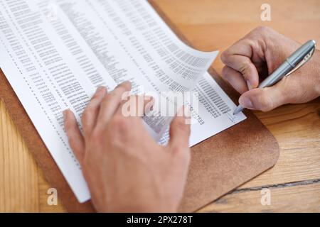 These documents need his initials. Cropped image of a businessmans hands initialing some paperwork. Stock Photo
