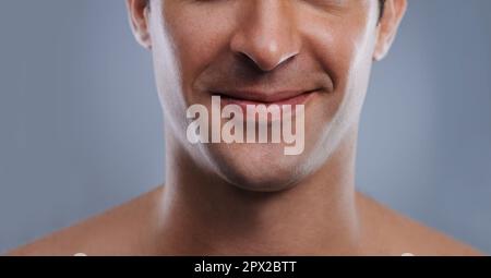 Kissable lips. Cropped image of a handsome mans mouth smiling. Stock Photo