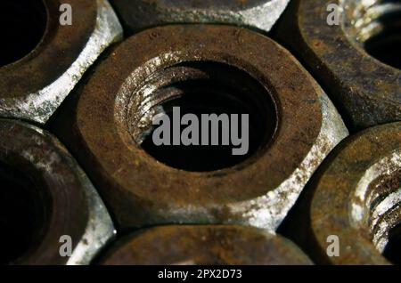 Closeup of a pile of rusty nuts. Retro industrial concept Stock Photo