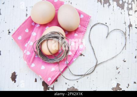Top view of three eggs on rose napkin. Stock Photo
