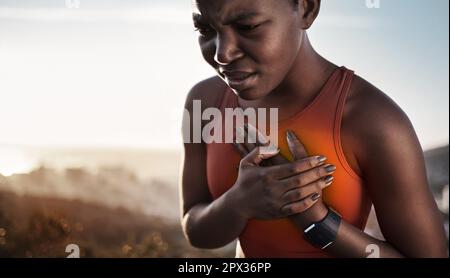 Heart pain, fitness and black woman with an injury from cardio, running and nature workout in Germany. Asthma, health and African runner with heart at Stock Photo