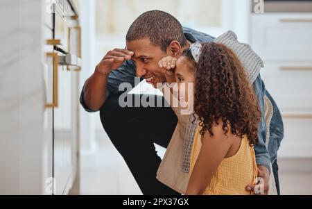 Family, baking or cooking while at oven waiting for food in home kitchen with a father and daughter together for bonding, help and support for dinner Stock Photo