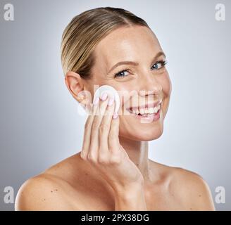 Woman, face or cotton pad for skincare grooming, dermatology cleaning product or facial acne treatment. Portrait, smile or happy beauty model with wip Stock Photo