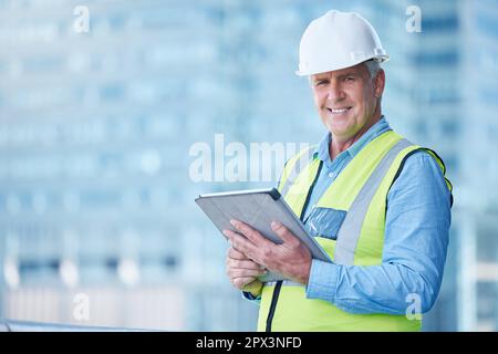 Many years have made me an expert. a mature male foreman using his digital tablet on site Stock Photo