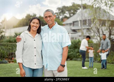 The memories we make with our family is everything. a daughter and father standing in the yard Stock Photo