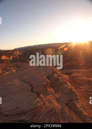 Navajo Indian at sunset near the Glen Canyon dam overlook in Page, Arizona. Playing a flute-like instrument that was very calming and emotional. Stock Photo