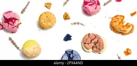 Broken round macarons with crumbs on a white background, delicious dessert, top view Stock Photo