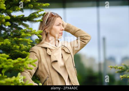 Pretty middle-aged woman looks into the distance Stock Photo