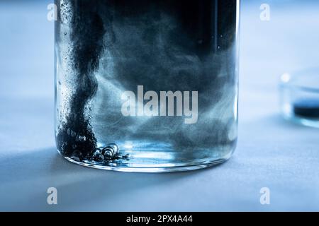 Iron nanoparticles in a lab, on a white glossy surface Stock Photo