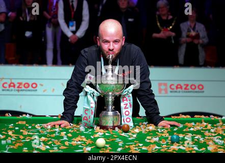 Sheffield, Britain. 1st May, 2023. Luca Brecel of Belgium celebrates with the trophy after winning the final against Mark Selby of England at the World Snooker Championship in Sheffield, Britain, May 1, 2023. Credit: Zhai Zheng/Xinhua/Alamy Live News Stock Photo