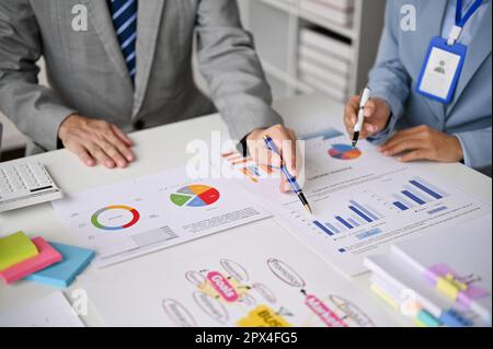 Cropped shot of a professional financial team are working and brainstorming on their financial investment project in the meeting together. Stock Photo