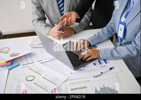 Cropped image of a professional financial analysts are examining and working on a financial investment project together in the meeting room. Stock Photo