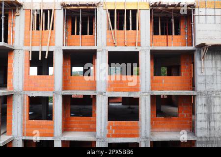 Red ceramic bricks at the construction site. Keramoblock. Hollow brick. Construction of a red brick building. Material for the construction of walls a Stock Photo