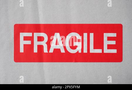 fragile warning sign label tag on a cardboard box Stock Photo - Alamy