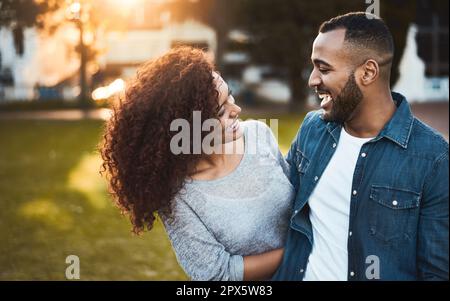 Romantic diverse couple hugging in grassy field · Free Stock Photo