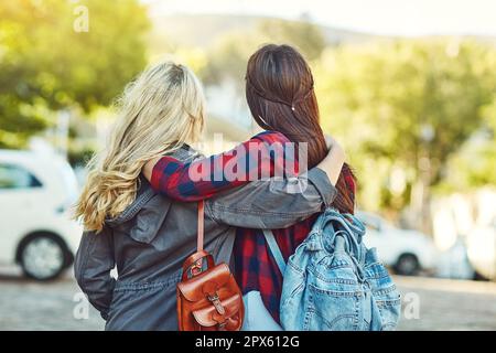 I wouldnt travel without my bestie. Rearview shot of two unrecognizable female friends sight seeing in the city Stock Photo