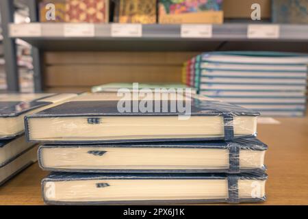Stack of black notebooks on display Stock Photo