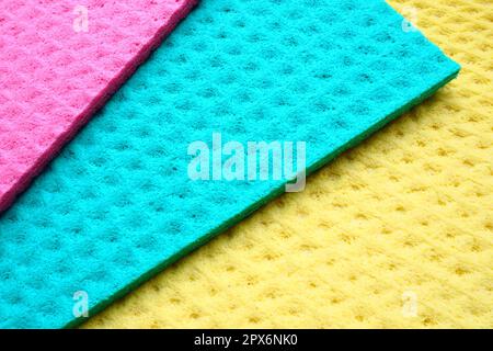 A set of cleaning wipes, microfiber cloths or sponges for the kitchen, three multi-colored cloths. Sponge fibers sponge texture pattern surface close- Stock Photo