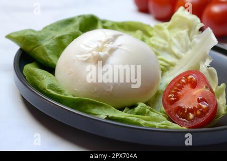 Burrata, burrata cheese on plate, fresh cheese from Italy Stock Photo