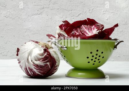 Cicorino rosso, lettuce (Cichorium intybus var. foliosum) plant in draining sieve Stock Photo