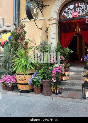 WARSAW, POLAND - JULY 15, 2022: Beautiful plants and lanterns near entrance in restaurant Stock Photo