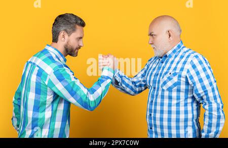 contradiction of two generation isolated on yellow. two contradiction of two generation in studio. Stock Photo