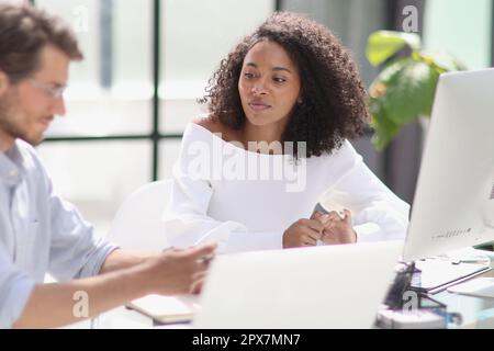 Software developers team discussing algorithms on computer screen Stock Photo
