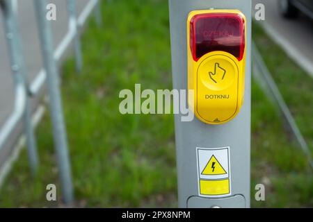 Yellow-red traffic light button touch and wait in Polish language Stock Photo
