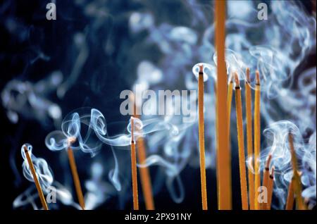 Scanned slide of historical color photograph showing smoke from incense sticks inside a Buddhist pagoda in Saigon, Vietnam Stock Photo