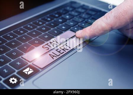 Conceptual caption Stay Alert, Word Written on Paying full attention to things around Quick to see or understand Stock Photo