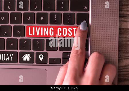 Writing displaying text Living Cost, Business approach the amount of money that a person needs to sustain life Stock Photo