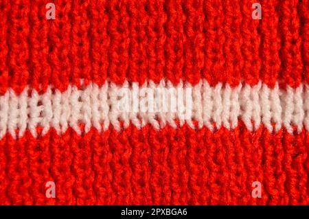 Pattern fabric made of wool. Handmade knitted fabric red and white wool background texture Stock Photo