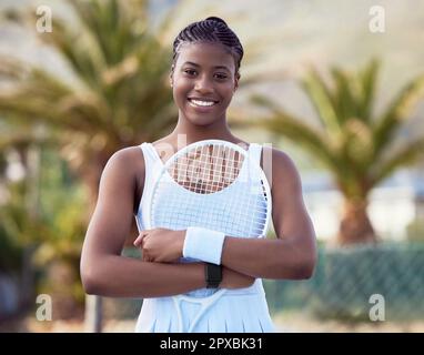 Most people give up just when theyre about to achieve. a young woman holding a racket on a tennis court. Stock Photo
