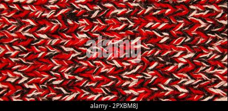 Pattern fabric made of wool. Handmade knitted fabric black white and red wool background texture Stock Photo