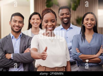 Ensure that your business armor is chink free. a team of businesspeople together with a businesswoman giving the thumbs up. Stock Photo