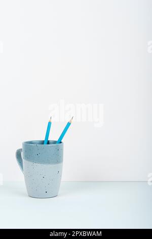 Coffee Cup Standing on Desk. Important infrormation written on paper. Stock Photo