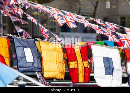 London, UK, 29 April 2023: The 40th annual Canalway Cavalcade takes place throughout the Mayday bank holiday weekend in London's Little Venice. Union Jack bunting and nautical flags decorate the canal boats moored at the pool where the Regent's Canal meets the Grand Union Canal. Anna Watson/Alamy Live News. Stock Photo