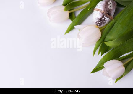 Festive composition with tulips and quail eggs. Easter background. Stock Photo