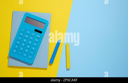 Blue notepad and markers on a blue background, top view Stock Photo