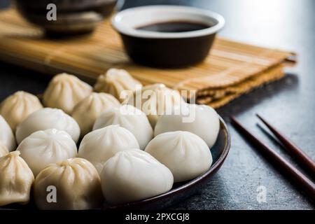 Xiaolongbao, traditional steamed dumplings. Xiao Long Bao buns on the plate. Stock Photo