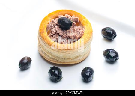 puff pastry filled with terrine served with black olives Stock Photo