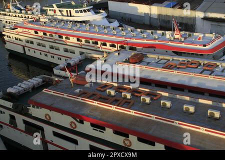 Ships are leaning on the harbor pier, side by side with each other Stock Photo