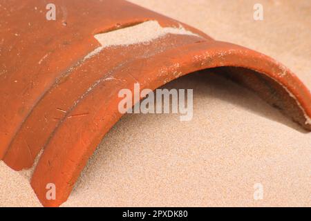 Old chimney washed up on beach Stock Photo