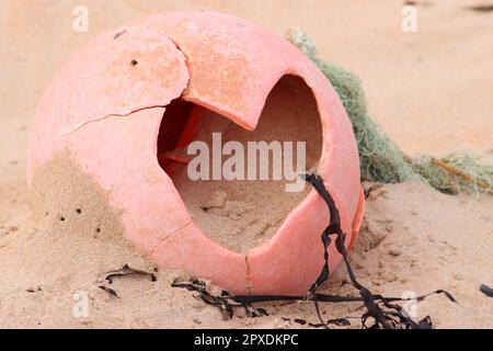 Plastic buoy washed up on beach Stock Photo