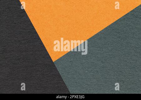 Texture of craft black, green and orange shade color paper background, macro. Structure of vintage abstract cardboard with geometric shape and gradien Stock Photo