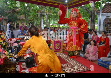 Shaman plays the role of a god performing rituals to transmit messages in Mother Goddess Worship event. North Vietnam. 越南旅游, 베트남 관광, ベトナム観光 hầu đồng Stock Photo