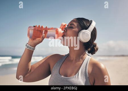 Gym Fitness Woman Earphones Drinking Water Bottle Cardio Workout While  Stock Photo by ©PeopleImages.com 620654246