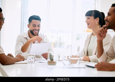 We laugh as a team, we work hard as a team. businesspeople having a meeting in a boardroom at work. Stock Photo