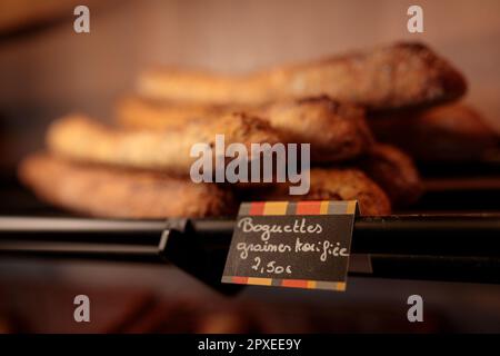 A array of freshly baked baguettes on display in a store Stock Photo
